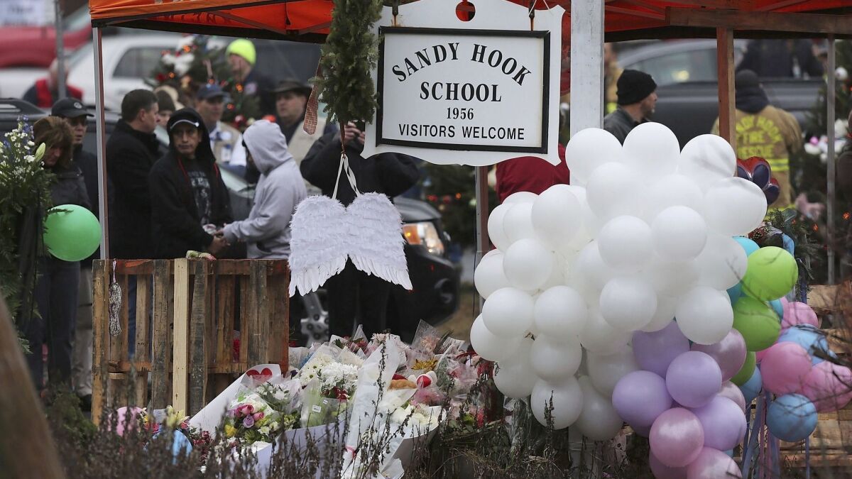 Flowers and balloons are left at Sandy Hook Elementary School after the mass killing in December 2012.