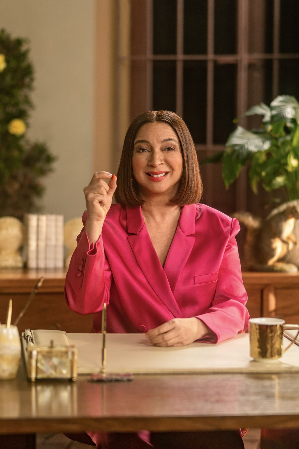 Maya Rudolph replaces 'polarizing' M&Ms spokescandies A woman sits at a desk while holding up a piece of candy