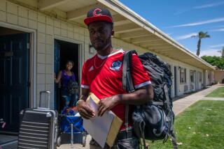 INDIO, CA - MAY 25: Haitian asylum seeker Beginne Moraney, who crossed the border with his wife Sandia Siverre and son Rood Moraney Siverre at an undisclosed motel provided by Galilee center in Indio, CA. (Irfan Khan / Los Angeles Times)