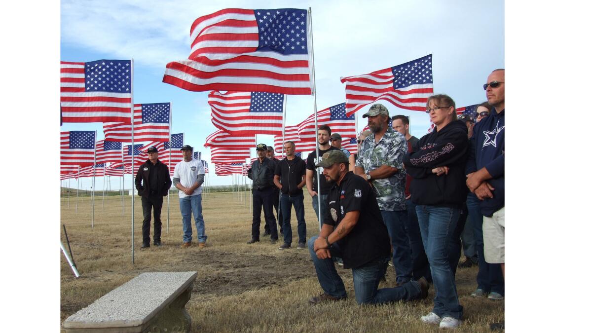 Locals gather July 1 at the Buffalo Chip Campground's Field of Flags near Sturgis, S.D., for a ceremony honoring veterans.