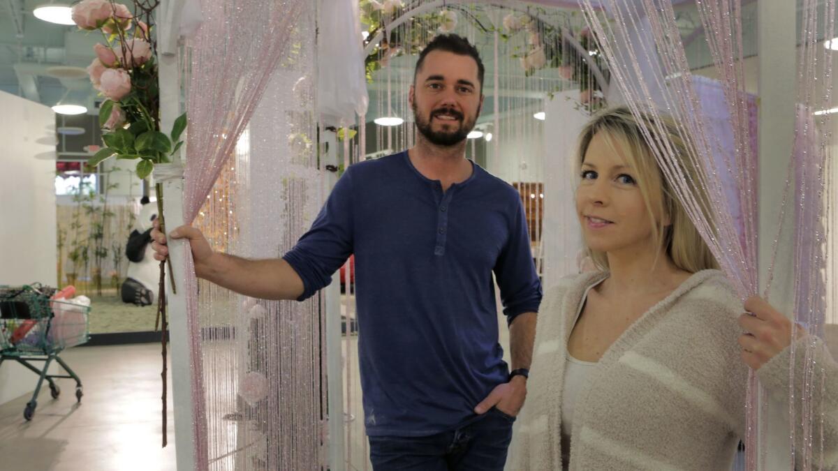 Married co-owners Kyle Hill and Ann Delaney of La Costa inside the gazebo exhibit of their newly opened pop-up exhibit "The Museum of What? Love Tour" in Encinitas.