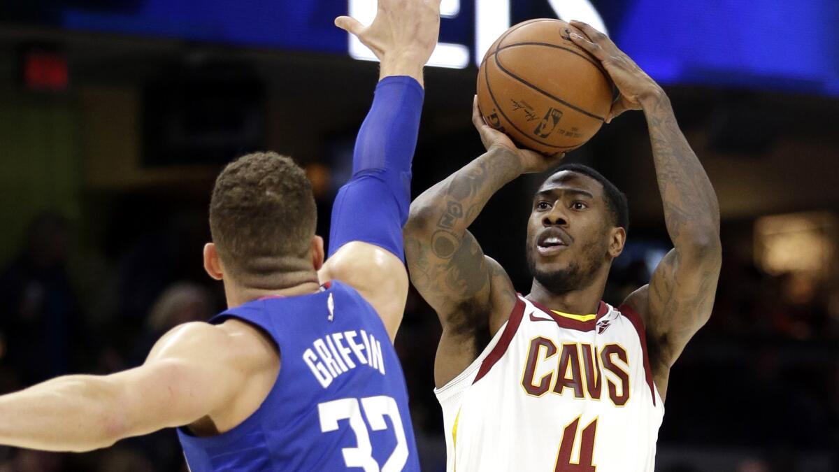 Cavaliers guard Iman Shumpert shoots over Clippers forward Blake Griffin during the first half of their game Friday night in Cleveland.