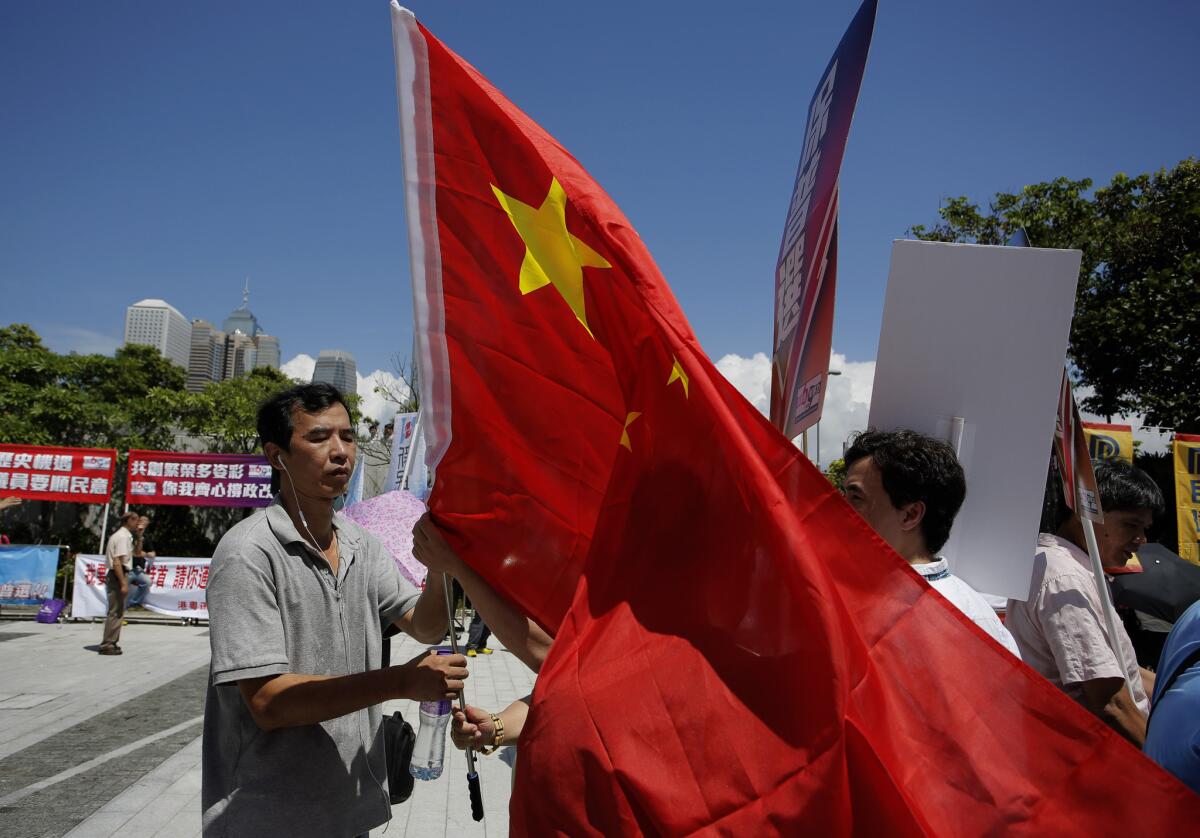Pro-Beijing supporters display a Chinese national flag outside the Legislative Council in Hong Kong.
