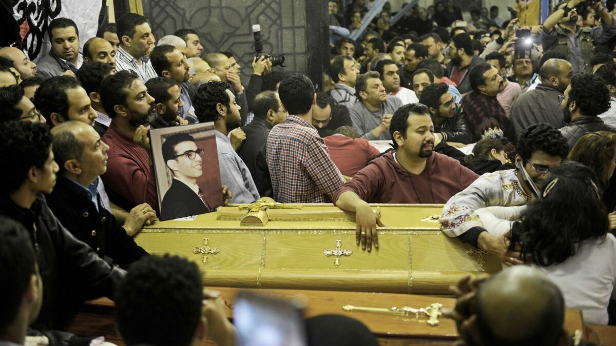 Relatives of the bomb victims grieve as coffins are taken into St. George's Church in Tanta, Egypt.