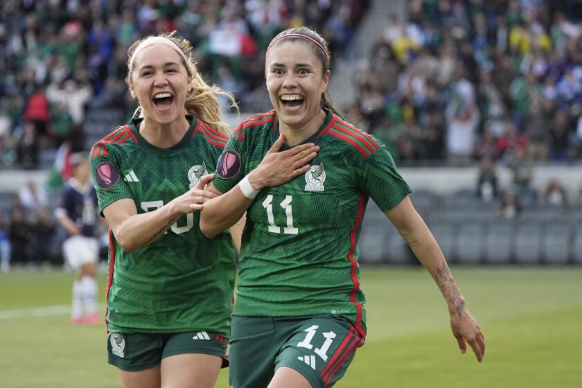 CORRECTS ID TO LIZBETH NOT JACQUELINE - Mexico midfielder Lizbeth Ovalle (11) celebrates her goal with forward Mayra Pelayo during the second half of a CONCACAF Gold Cup women's soccer tournament quarterfinal against Paraguay, Sunday, March 3, 2024, in Los Angeles. (AP Photo/Marcio Jose Sanchez)