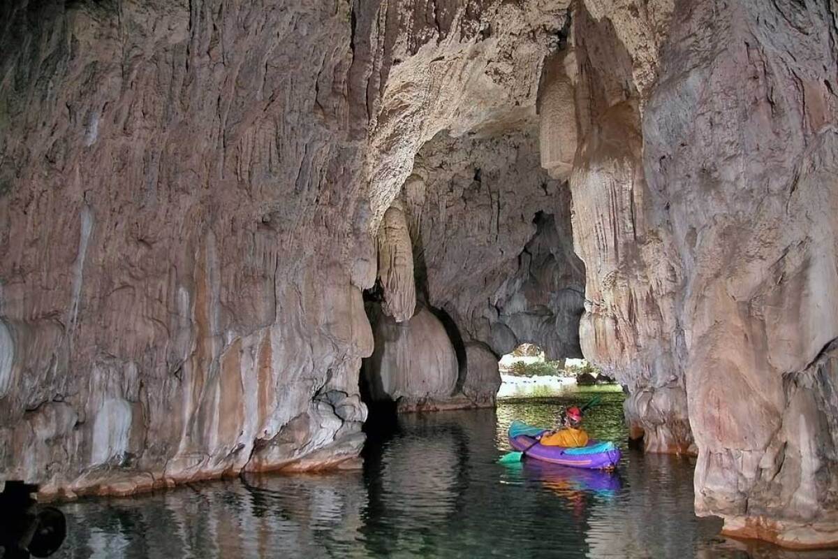 A kayaker in a cave at Natural Bridges Trailhead swimming hole.