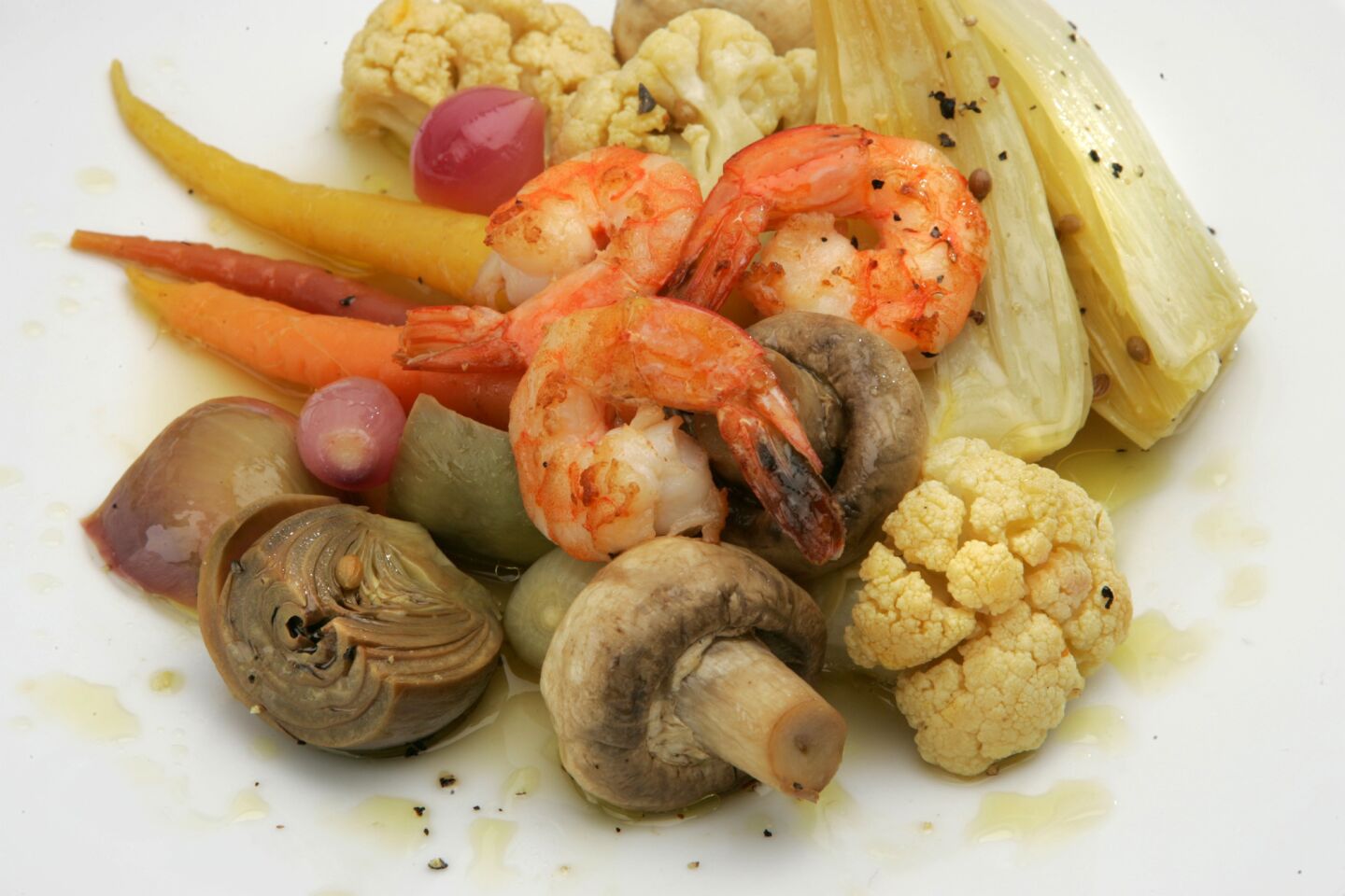 Mushrooms, cauliflower, artichokes, carrots, onions and fennel quickly simmered in a vibrant court bouillon and served with sauteed shrimp.