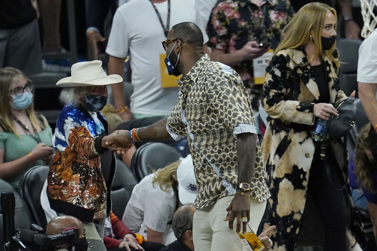 Lakers star LeBron James greets fan James Goldstein during Game 5 of the NBA Finals.
