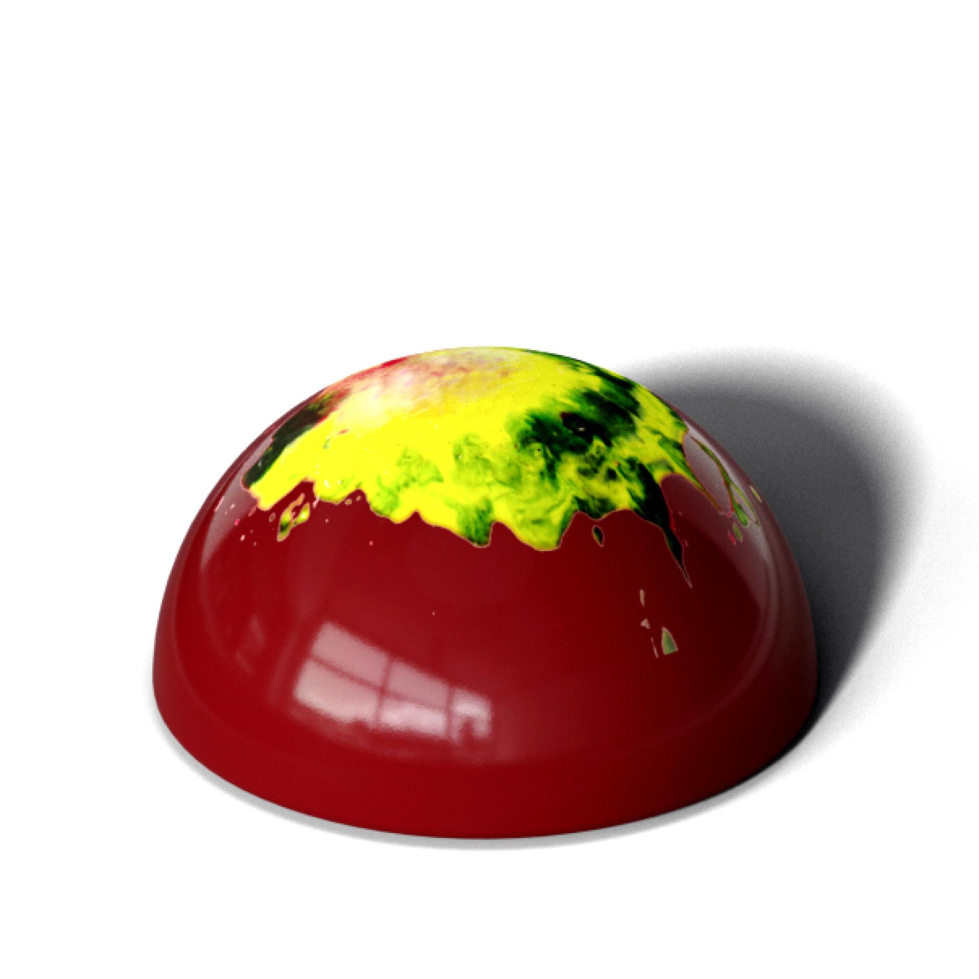 A photo of a red, dome-shaped piece of chocolate.