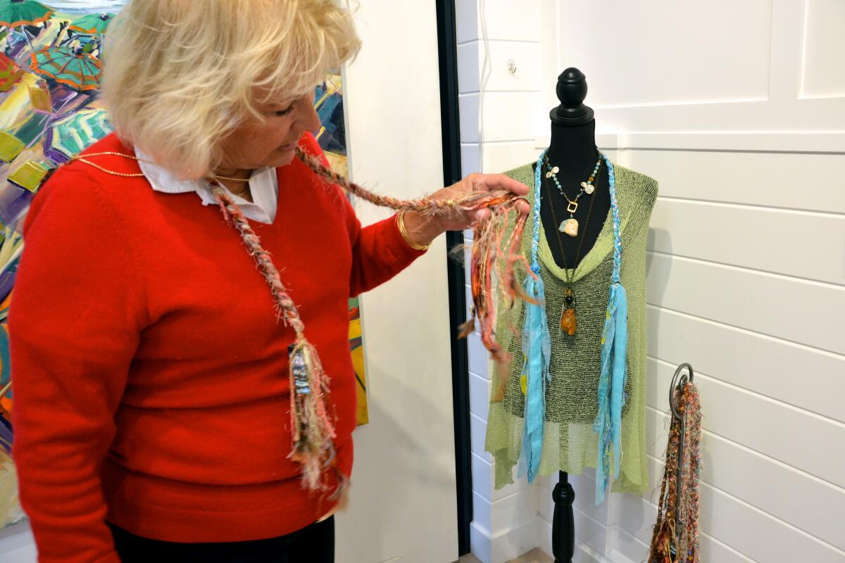 Balboa Island Gallery owner, Kim Rossall describes the lariat style woven scarves from artist/designer Dyan Rogers.