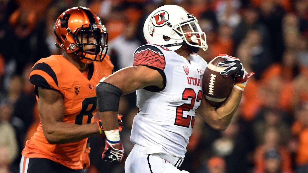Utah running back Devontae Booker, right, finds room to run in front of Oregon State safety Tyrequek Zimmerman during the Utes' victory on Oct. 16.
