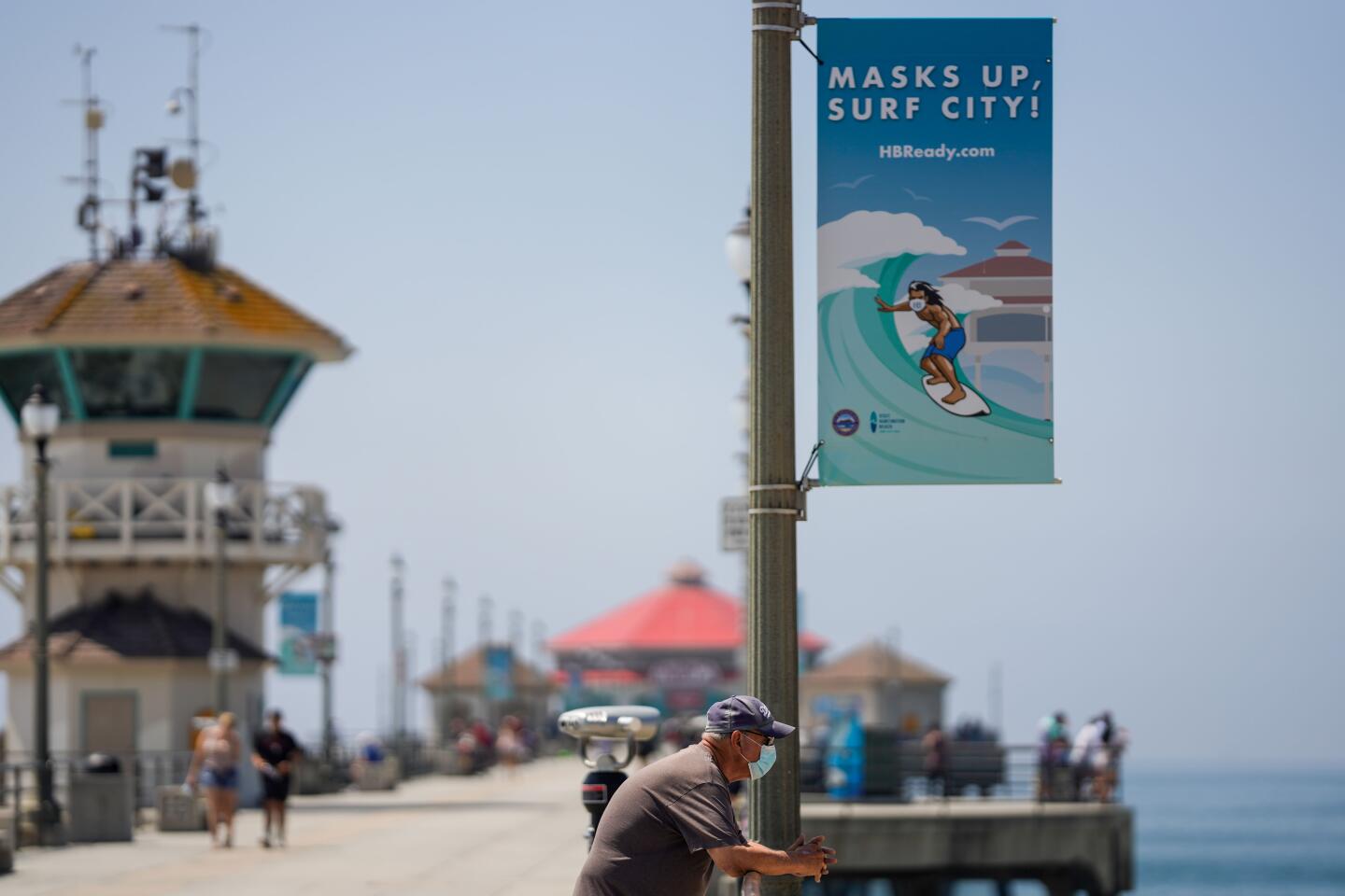 People visit the Huntington Beach Pier ahead of a hot Labor Day weekend.
