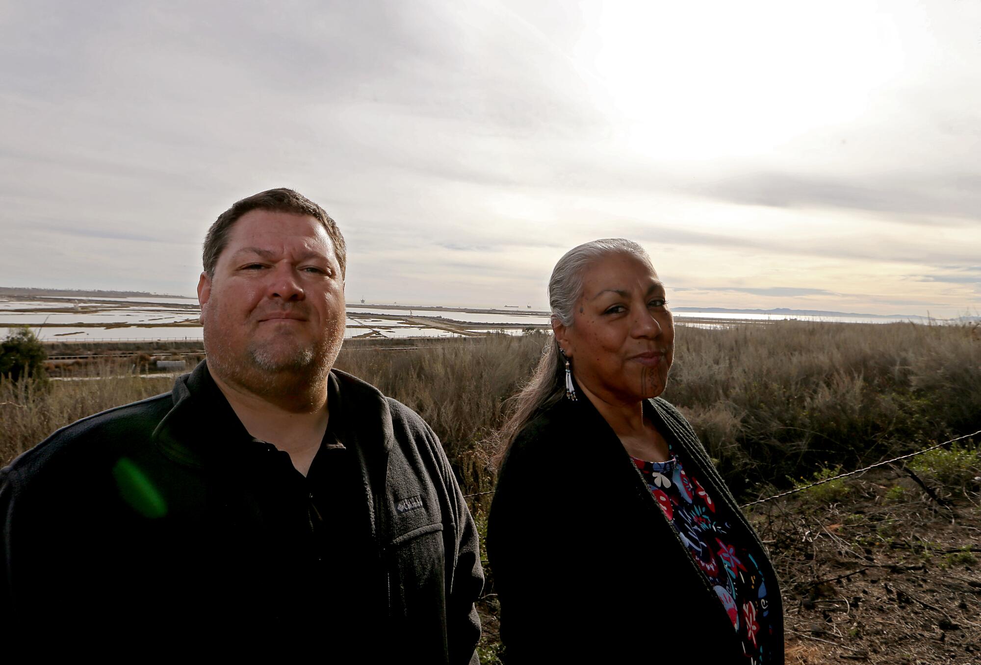 Dustin Murphey and Tina Calderon stand on coastal land that has been returned to Indigenous tribes.