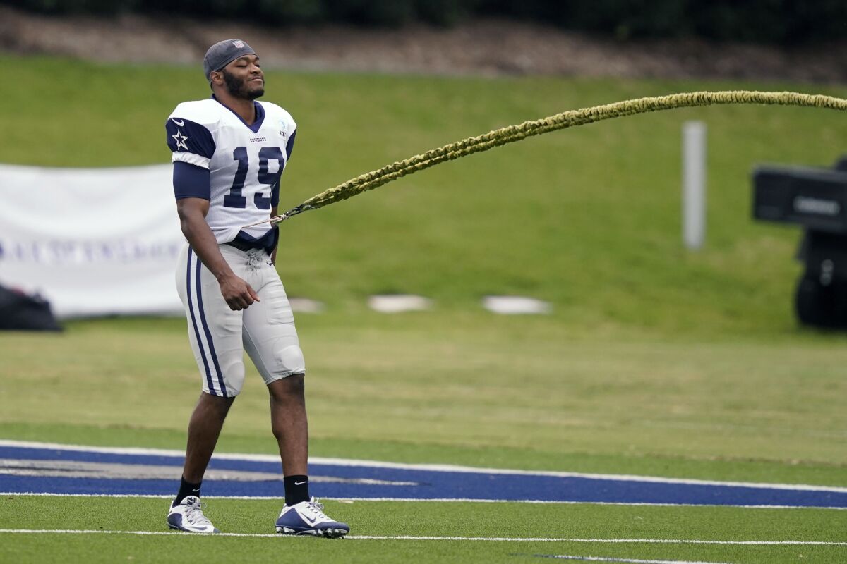 Dallas Cowboys wide receiver Amari Cooper (19) works a solo drill during an NFL training camp football practice in Frisco, Texas, Thursday, Sept. 3, 2020. (AP Photo/LM Otero)