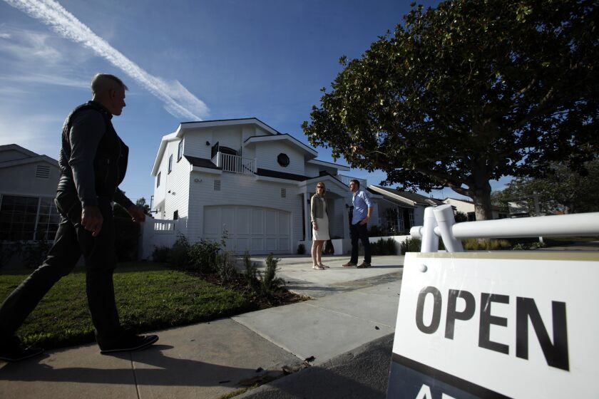 Prospective buyers meet their real estate agent at a house in Westchester. Home sales and median prices both climbed in Southern California in April.