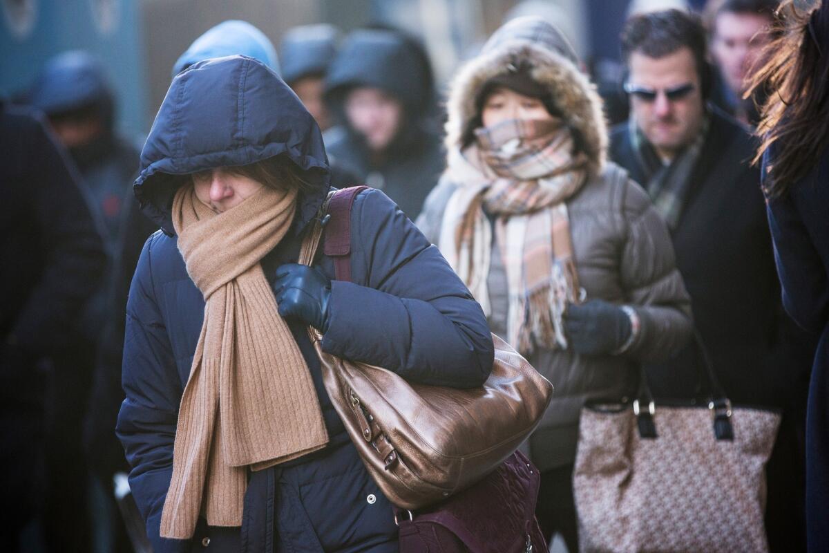 Morning commuters in New York bundle up. The latest cold snap across the country has prompted a flex alert in California.