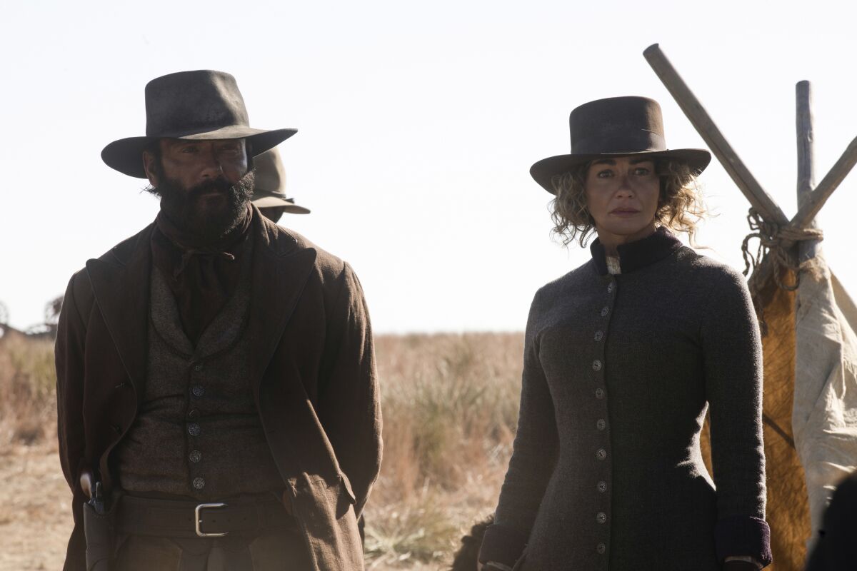 This image provided by Paramount+ shows Tim McGraw as James, left, and Faith Hill as Margaret in a scene from "1883." (Emerson Miller/Paramount+ via AP)