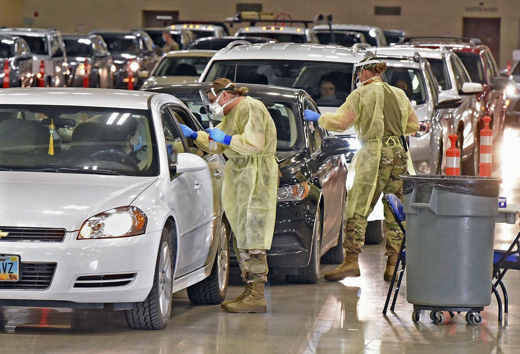 Workers administer coronavirus tests inside the Bismarck Events Center in Bismarck, N.D.