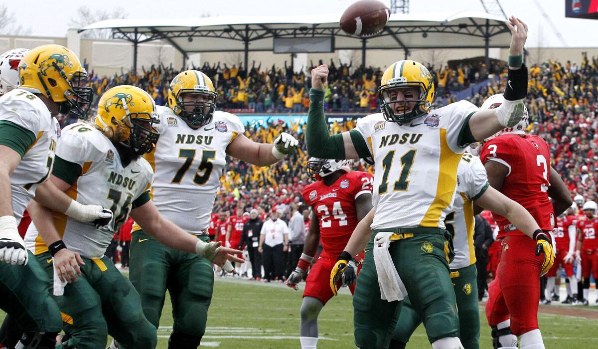 North Dakota State quarterback Carson Wentz (11) celebrates with teammates after scoring the go-ahead touchdown against the Illinois State on a five-yard run in the final minute of the FCS championship game Saturday.