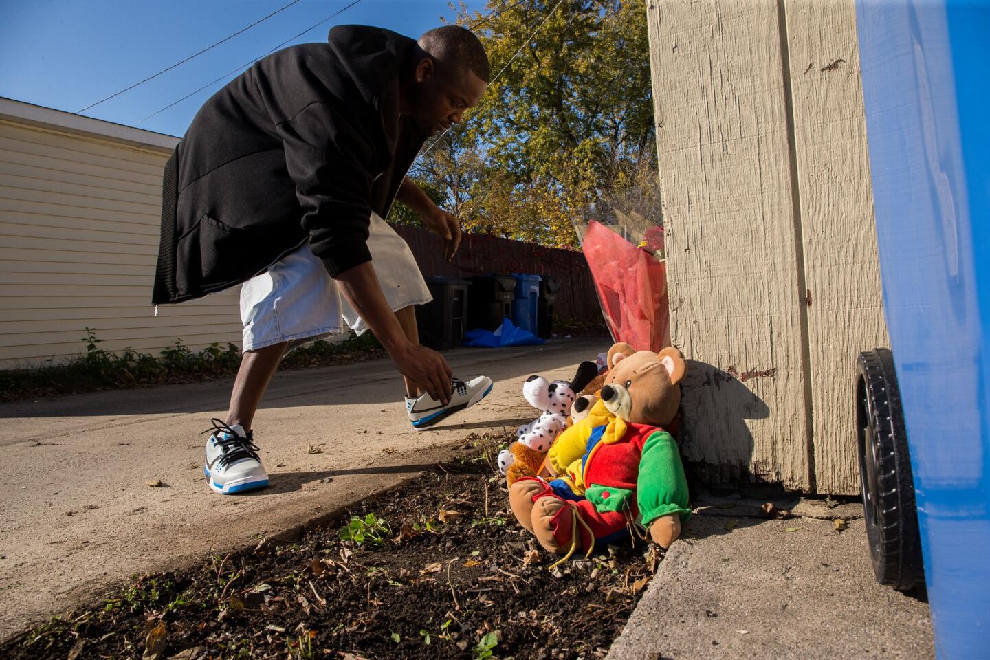 Antwan Burns-Jones, 31, puts up a memorial to Tyshawn Lee on Nov. 3, 2015. The nine-year-old was fatally shot a day earlier in the 8000 block of South Damen Avenue in Chicago's Gresham neighborhood.