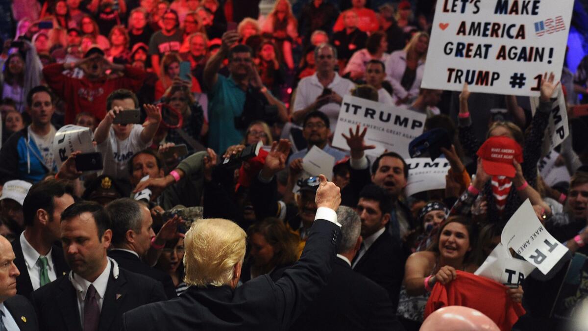 Candidate Donald Trump waves to the crowd during an April rally at the Orange County Fairgrounds in Costa Mesa.