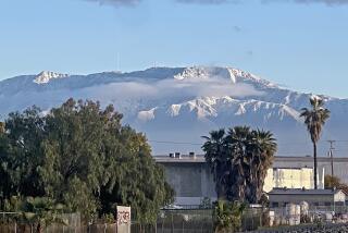 After a cold front passed, the snow-capped San Gabriel Mountains can be seen, with Mount Wilson at center, from Whittier Blvd. at the San Gabriel River, in Pico Rivera on Sunday morning, Feb. 26, 2023.