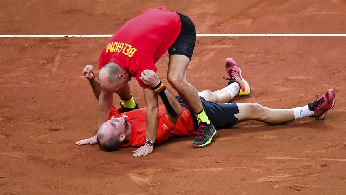 Belgium's Steve Darcis looks up to captain Johan Van Herck after winning defeating Australia's Jordan Thompson during a Davis Cup semifinal singles match Sunday in Paris.