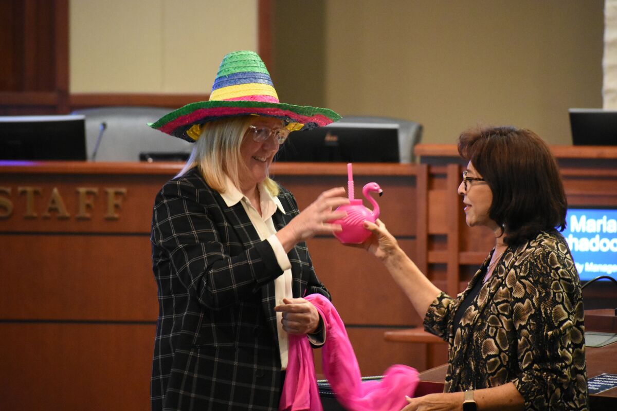 Chula Vista Mayor Mary Casillas Salas offers gifts to Kelley Bacon, who retired last week as deputy city manager.