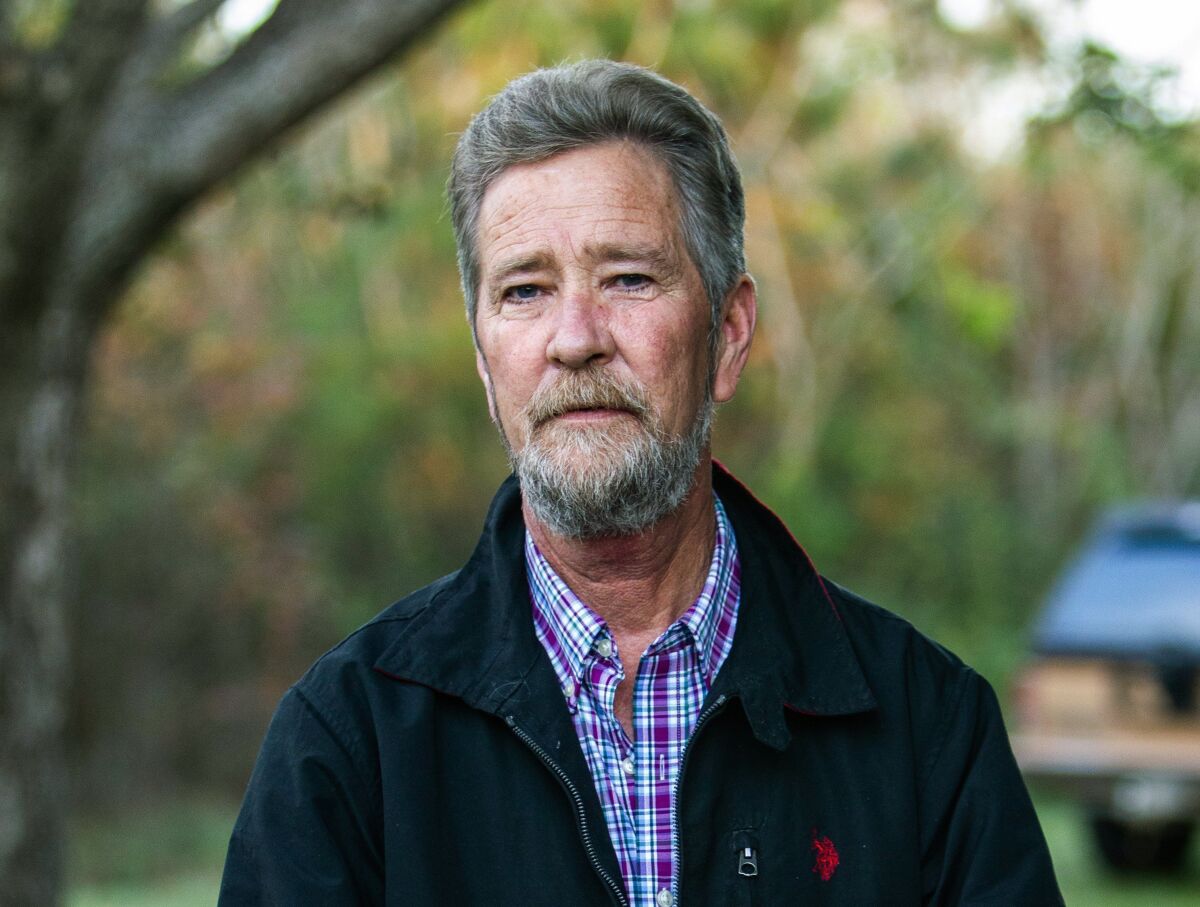 FILE - In this Dec. 5, 2018 file photo, Leslie McCrae Dowless Jr. poses for a portrait outside of his home in Bladenboro, N.C. The key player in a North Carolina ballot fraud probe that led to a new congressional election was sentenced Thursday, Sept. 2, 2021 to six months in prison for obtaining illegal Social Security benefits while concealing payments for political work he performed. (Travis Long/The News & Observer via AP, File)