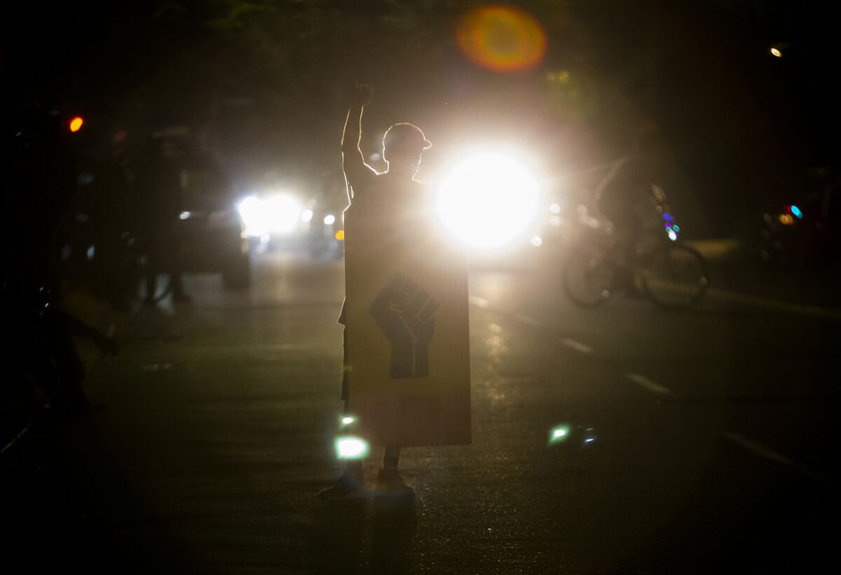 Police declared a riot around midnight as Portland protests continued for the 80th consecutive night Saturday, Aug. 15, 2020. Protesters gathered at Laurelhurst Park Saturday evening before marching to the Penumbra Kelly building. (Dave Killen/The Oregonian via AP)
