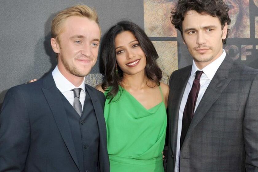 Actors Tom Felton, left, Freida Pinto, and James Franco, who star in "Rise of the Planet of the Apes," arrive for the film's premiere at Grauman's Chinese Theatre in Hollywood. The film, an origin story for the "Planet of the Apes" franchise, is set in present-day San Francisco.