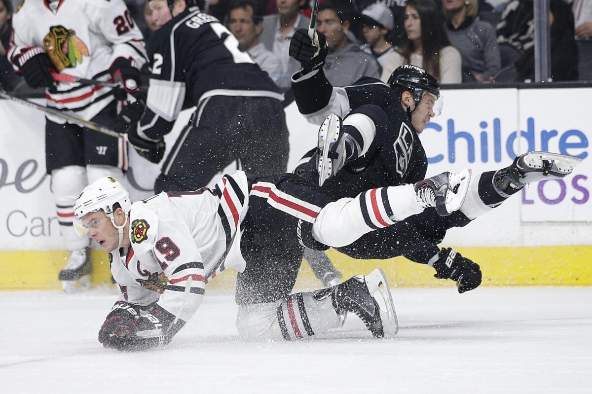 Brayden McNabb, right, collides with Chicago's Jonathan Toews during the Kings' 4-1 loss Saturday at Staples Center.