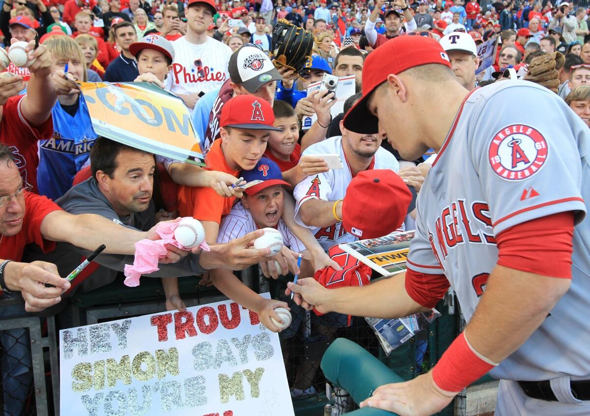 Mike Trout signs autographs for some fans Tuesday in Philadelphia before the Angels played the Phillies.