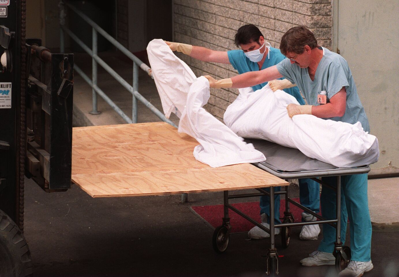 Medical examiner's employees prepare to wheel inside the agency's Kearny Mesa office a body removed the Rancho Santa Fe masnion where the Heaven's Gate mass suicide was discovered on March 26, 1997.