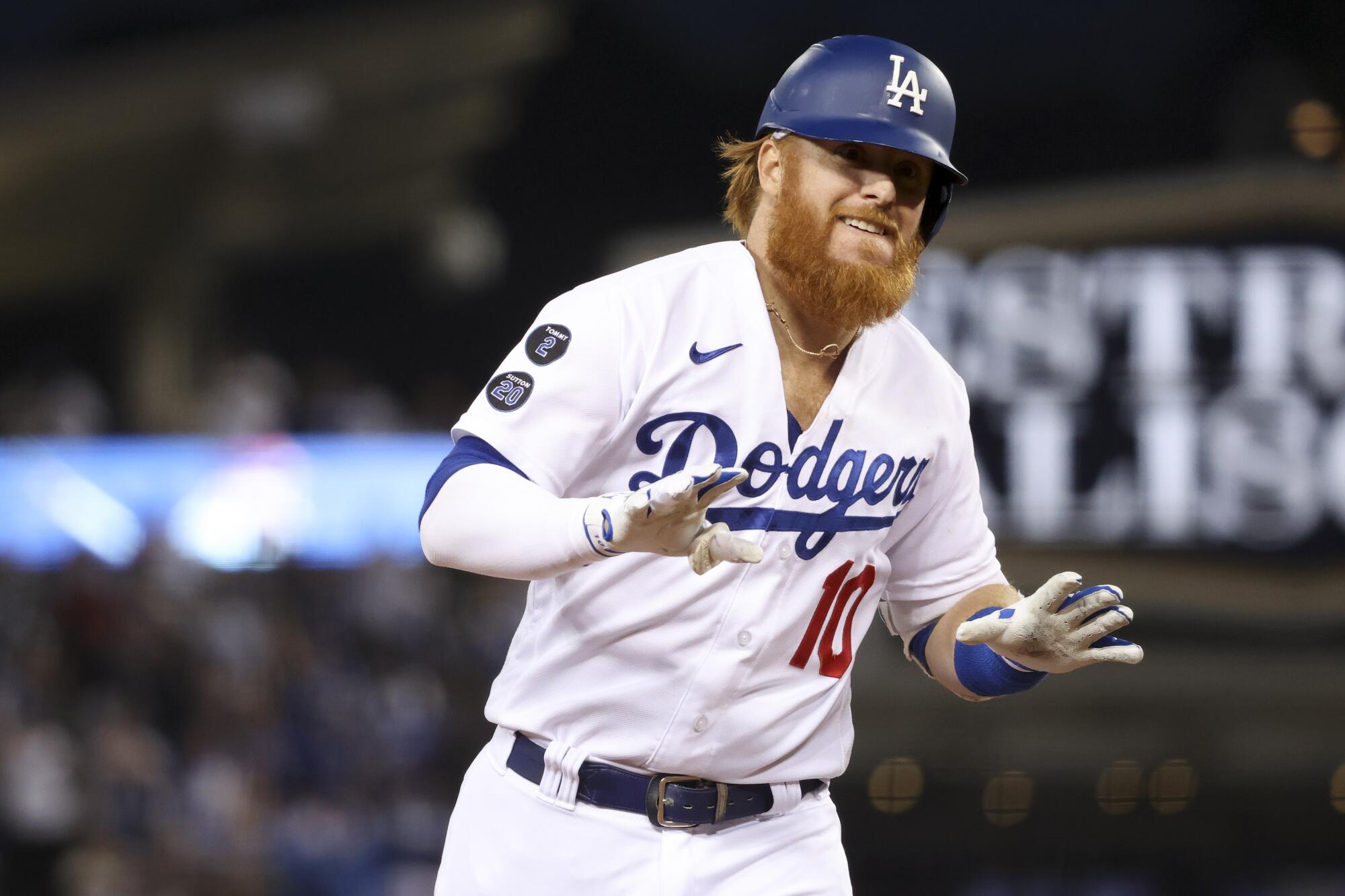 Los Angeles Dodgers' Justin Turner rounds the bases after hitting a solo home run to tie the game