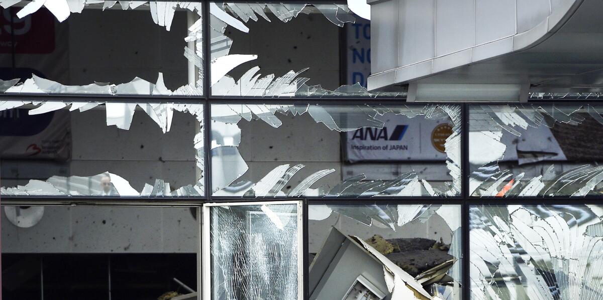 A blown out window in the terminal at Brussels Airport on Wednesday, a day after two suicide bombers set off explosives in the departures hall.