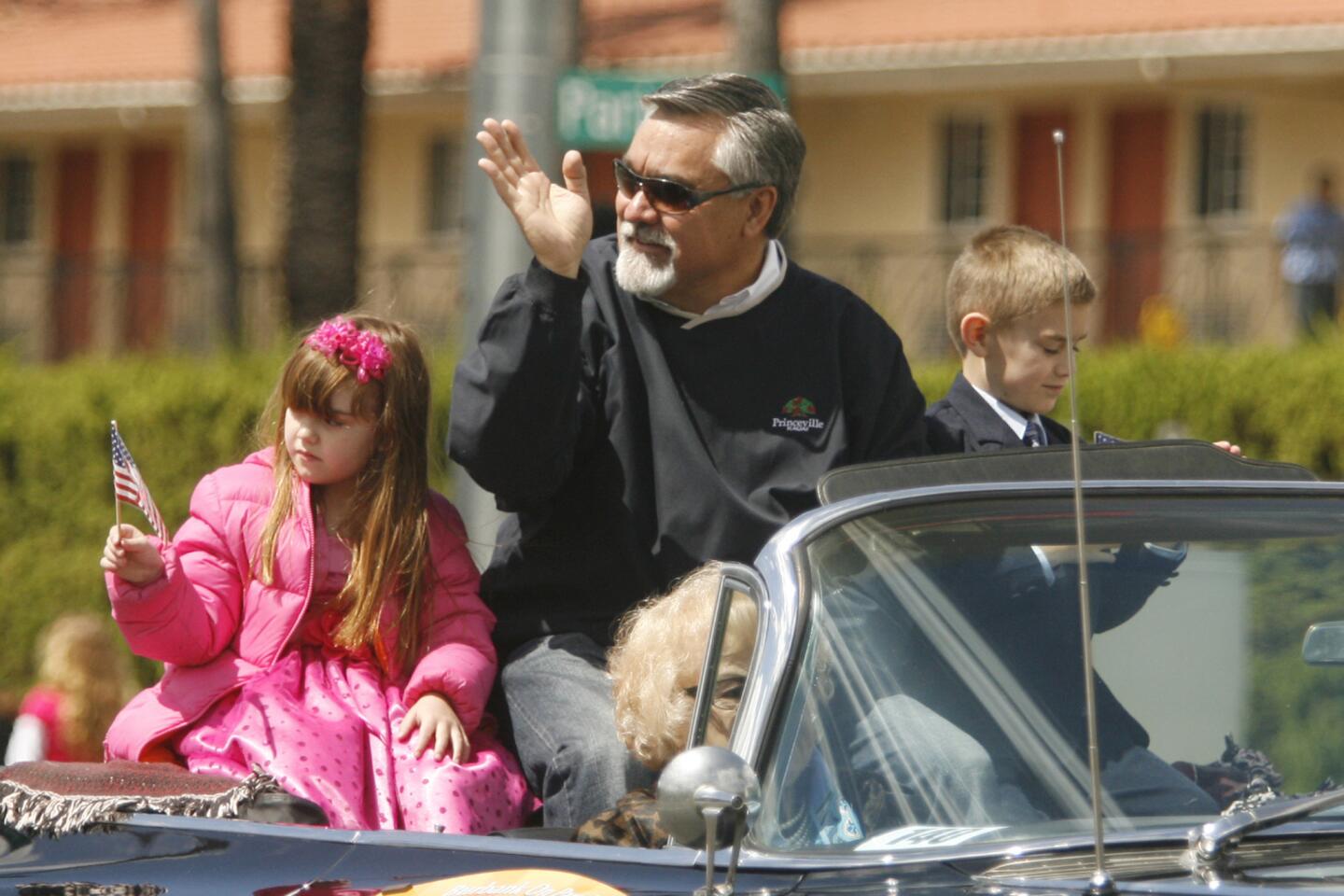 Mayor Jess Talamantes, center, waves to onlookers as he brings along his niece, Emma, 5, left, and his nephew, Joshua, 7, during Burbank on Parade, which took place on Olive Ave. between Keystone St. and Lomita St. on Saturday, April 14, 2012.
