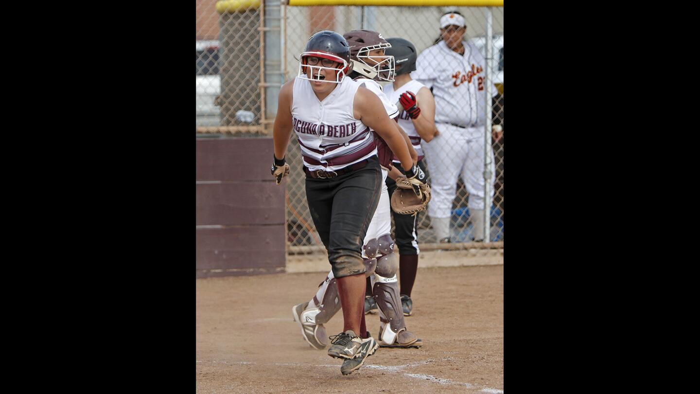 Laguna Beach High's Cinema Wunder cheers after stealing home plate against Estancia during the sixth inning in an Orange Coast League softball game on Monday, April 30.