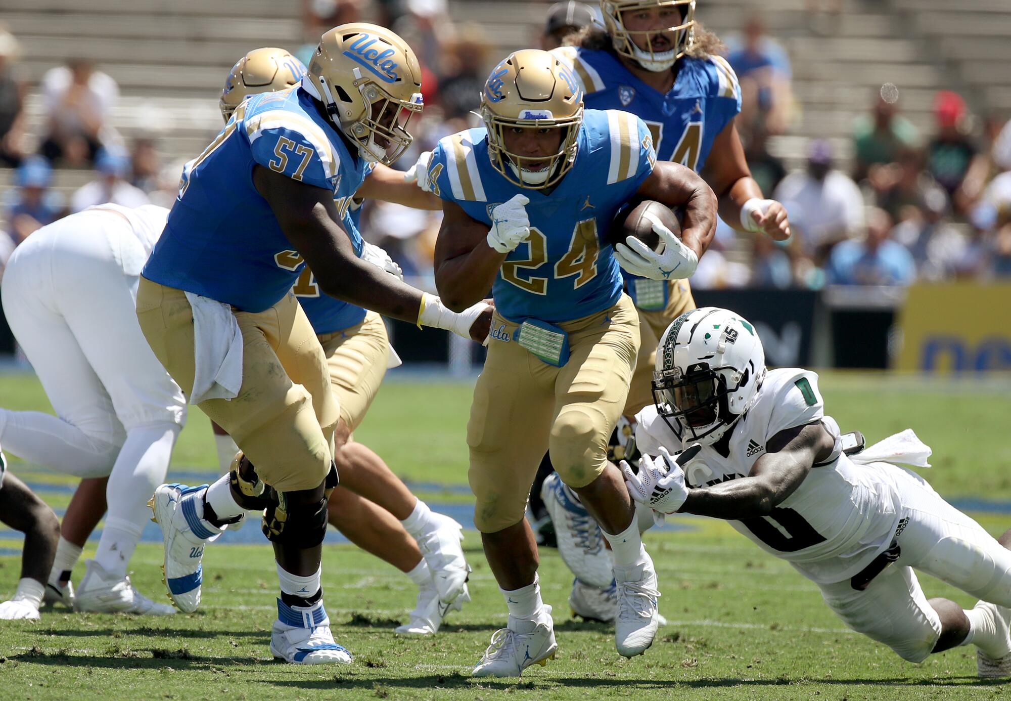 UCLA running back Zach Charbonnet breaks free for a touchdown run against Hawaii in the first quarter.