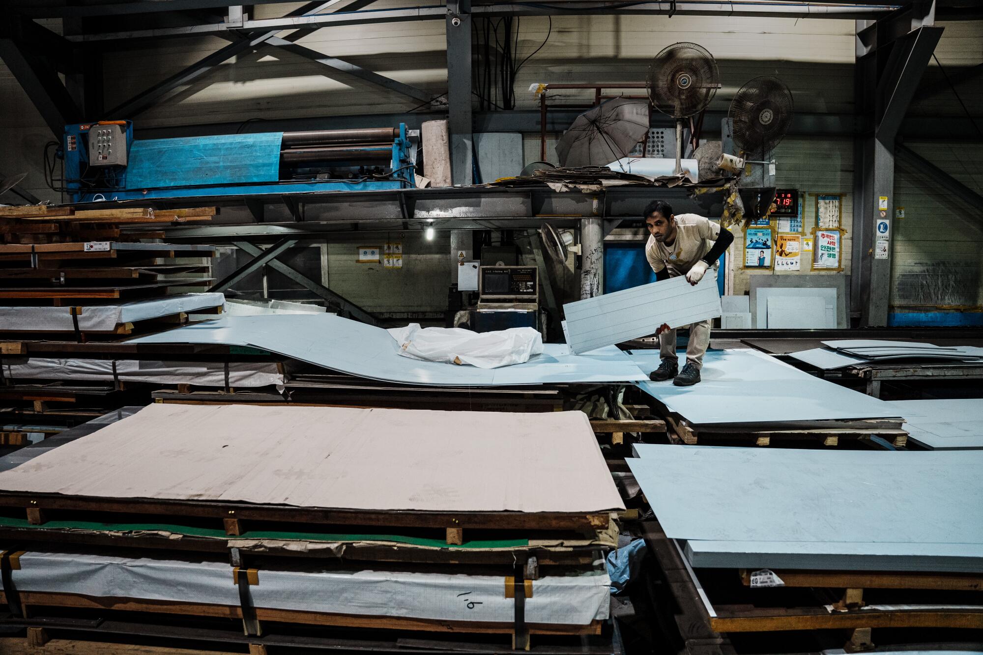 A person works in a sheet metal factory