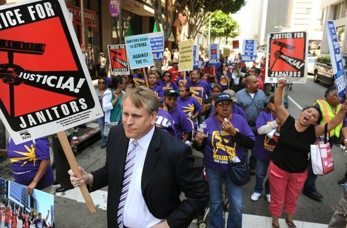 Scott Svonkin, a member of the Board of Trustees at the L.A. Community College District, joins demonstrators in downtown Los Angeles during a tax protest Tuesday.