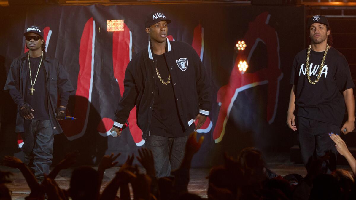 N.W.A members Eazy-E (Jason Mitchell), from left, Dr. Dre (Corey Hawkins) and Ice Cube (O’Shea Jackson Jr.) take center stage in “Straight Outta Compton.”