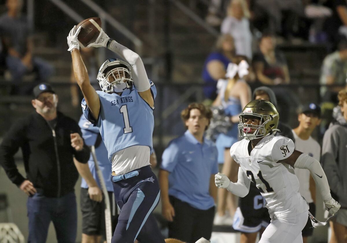 Cooper Hoch (1) of Corona del Mar makes a leaping catch against San Juan Hills on Thursday at Davidson Field.