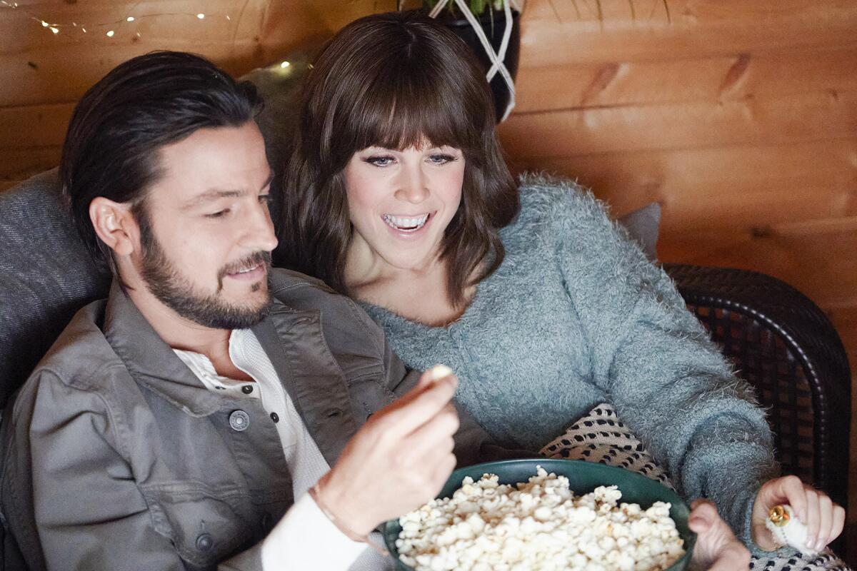 Couple on couch with popcorn