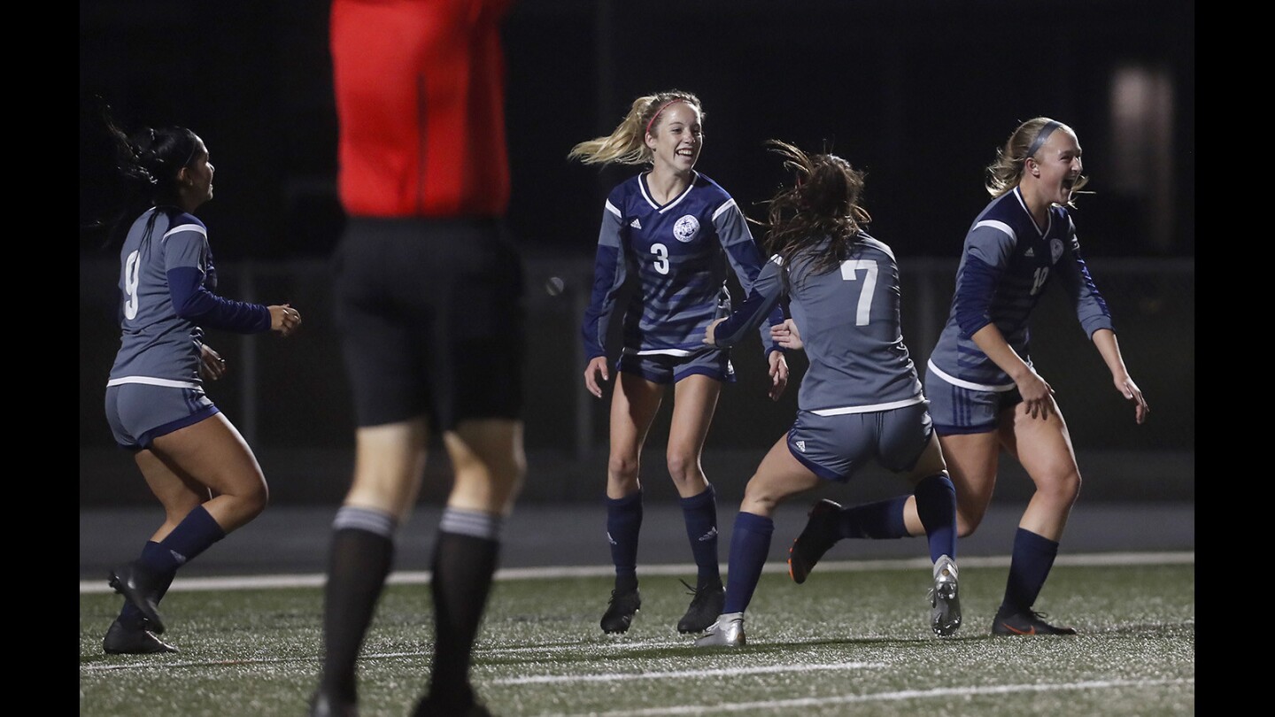 Newport Harbor High's Reese Bodas (3) celebrates her goal with teammates during the first half against Edison in a Sunset Conference crossover match at Newport Harbor High on Tuesday, December 18, 2018.