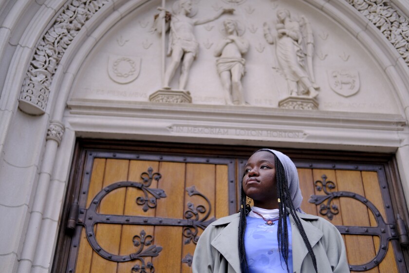 Nathalie Charles poses for a portrait outside the Princeton University Chapel in Princeton, N.J. on Wednesday, Dec. 8, 2021. Charles left her Baptist church at the age of 15 because as a queer woman of Haitian descent, she felt unwelcome in her congregation, with its conservative views on immigration, gender and sexuality. The 18-year-old freshman at Princeton has since identified as atheist, and then agnostic, before embracing a spiritual but not religious life. (AP Photo/Luis Andres Henao)