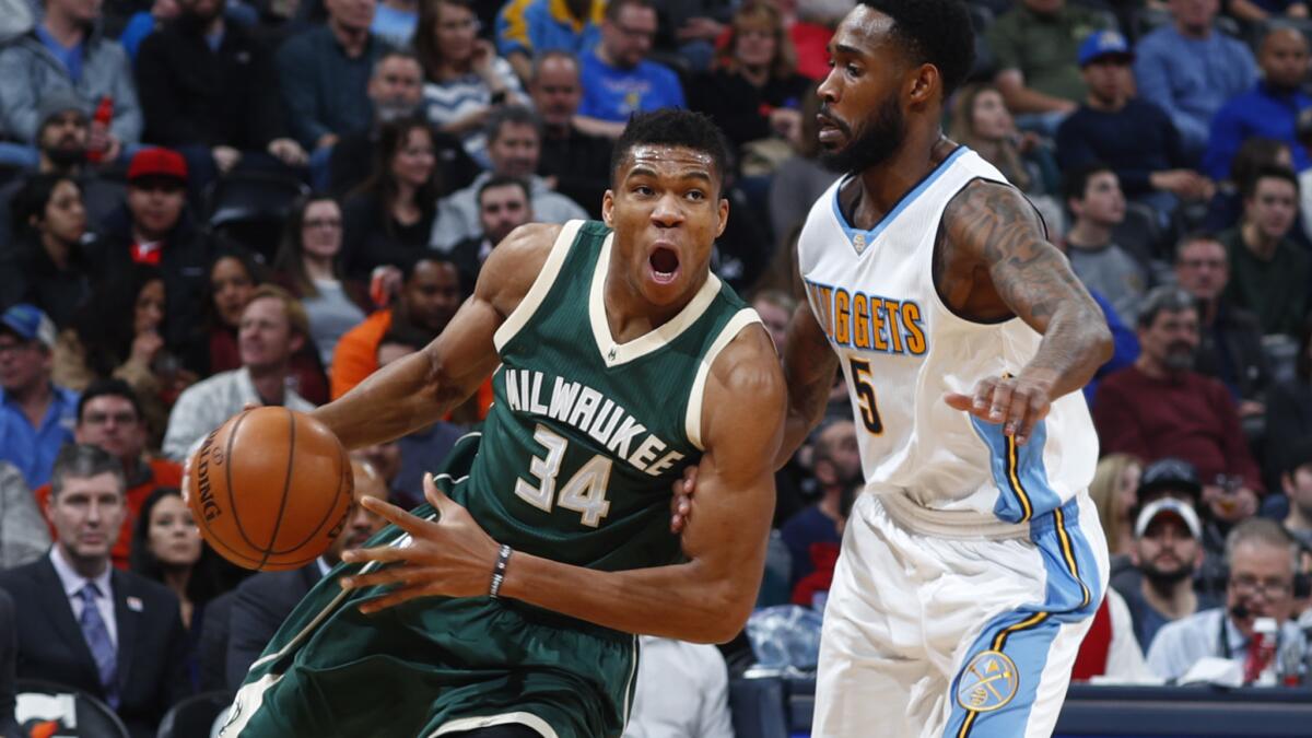 Bucks forward Giannis Antetokounmpo drives against Nuggets guard Will Barton during a game Feb. 3.
