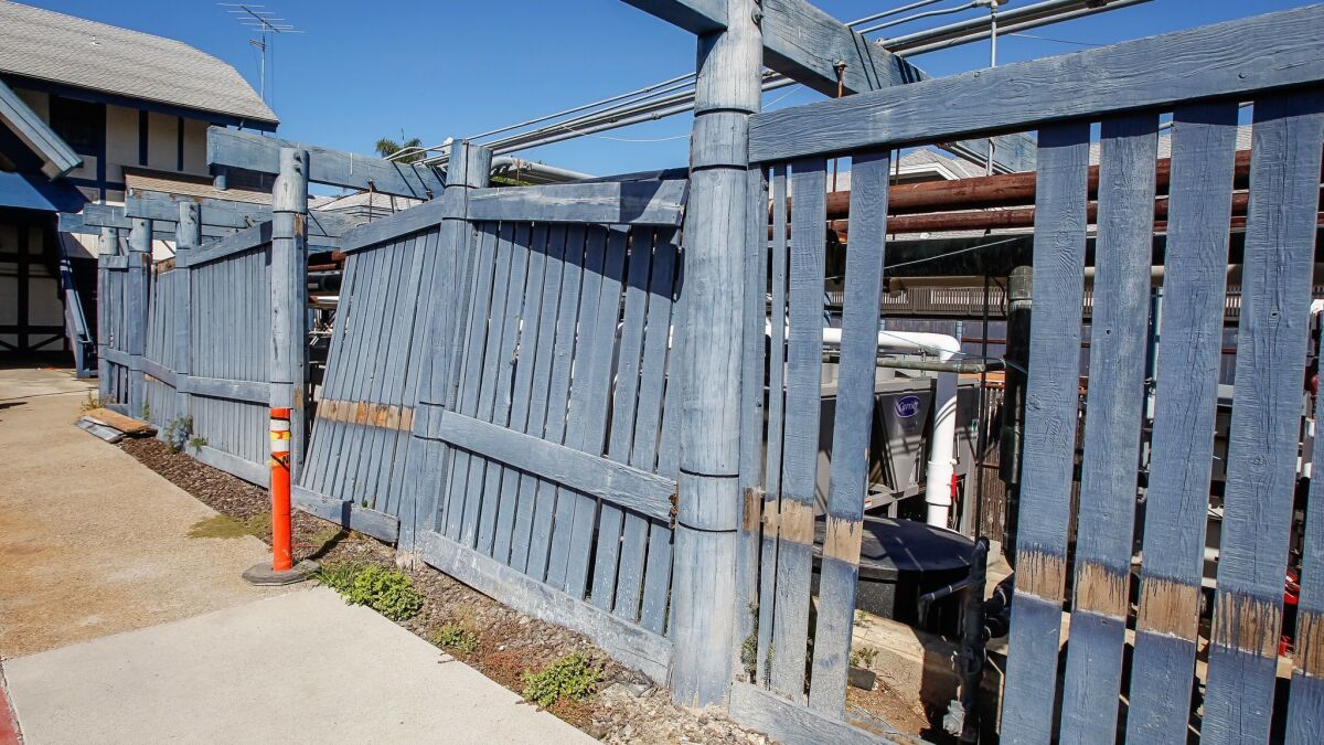 This decrepit fence and support structure for gas and water lines will soon be replaced by the owner of Carlsbad's iconic windmill building.