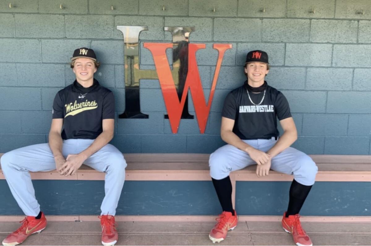 Bryce Rainer and Duncan Marsten in uniform sit on a bench.