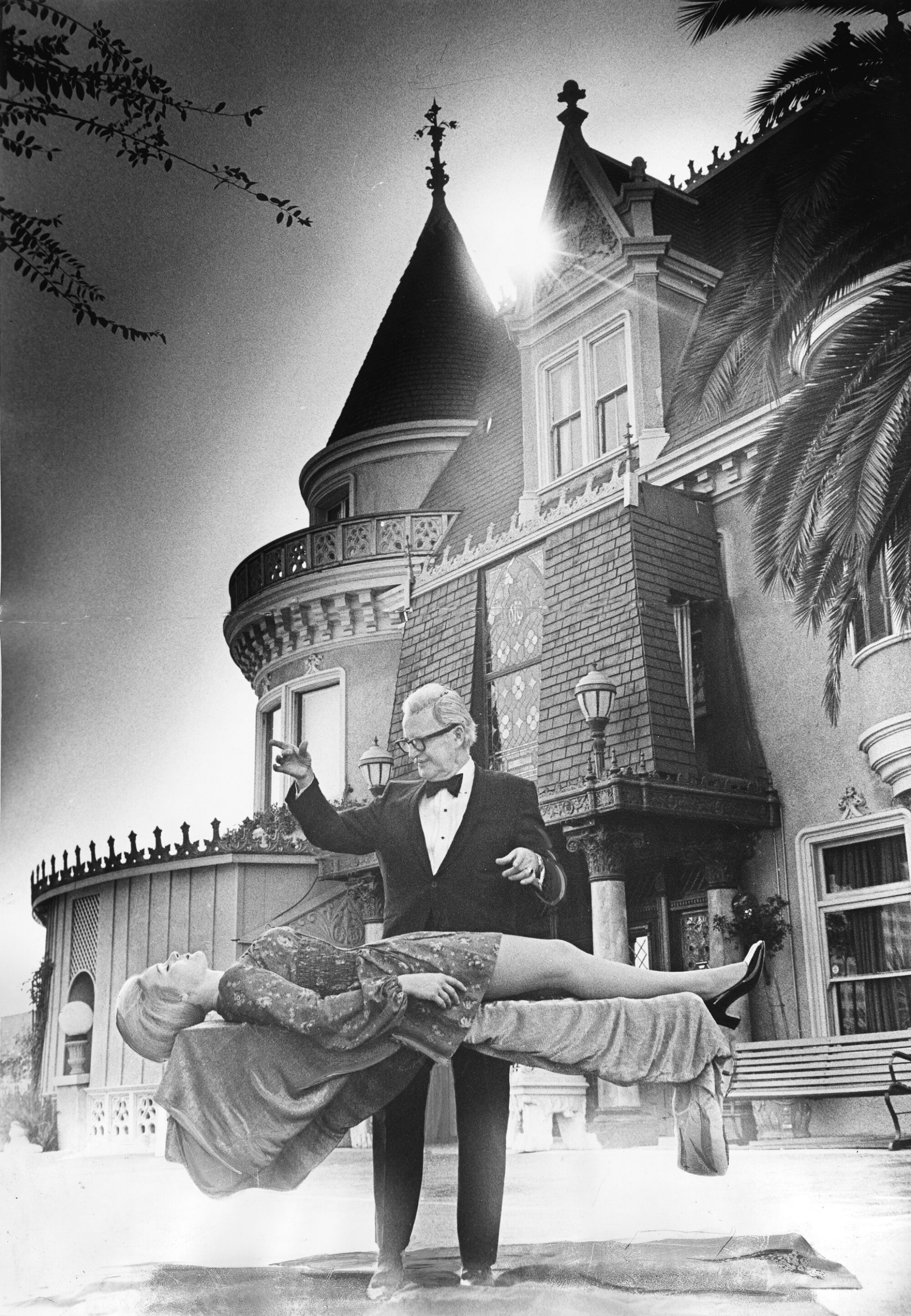 A 1970 photo of magician Dai Vernon levitating Magic Castle co-founder Irene Larsen outside the Magic Castle.